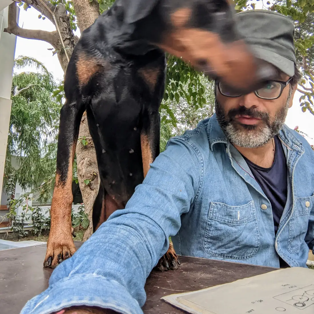 Udai and the dogs helping him finish farm diagrams
