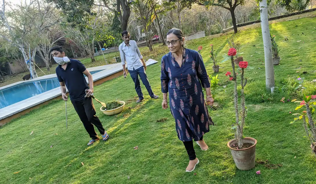 Mama working with the boys in the garden