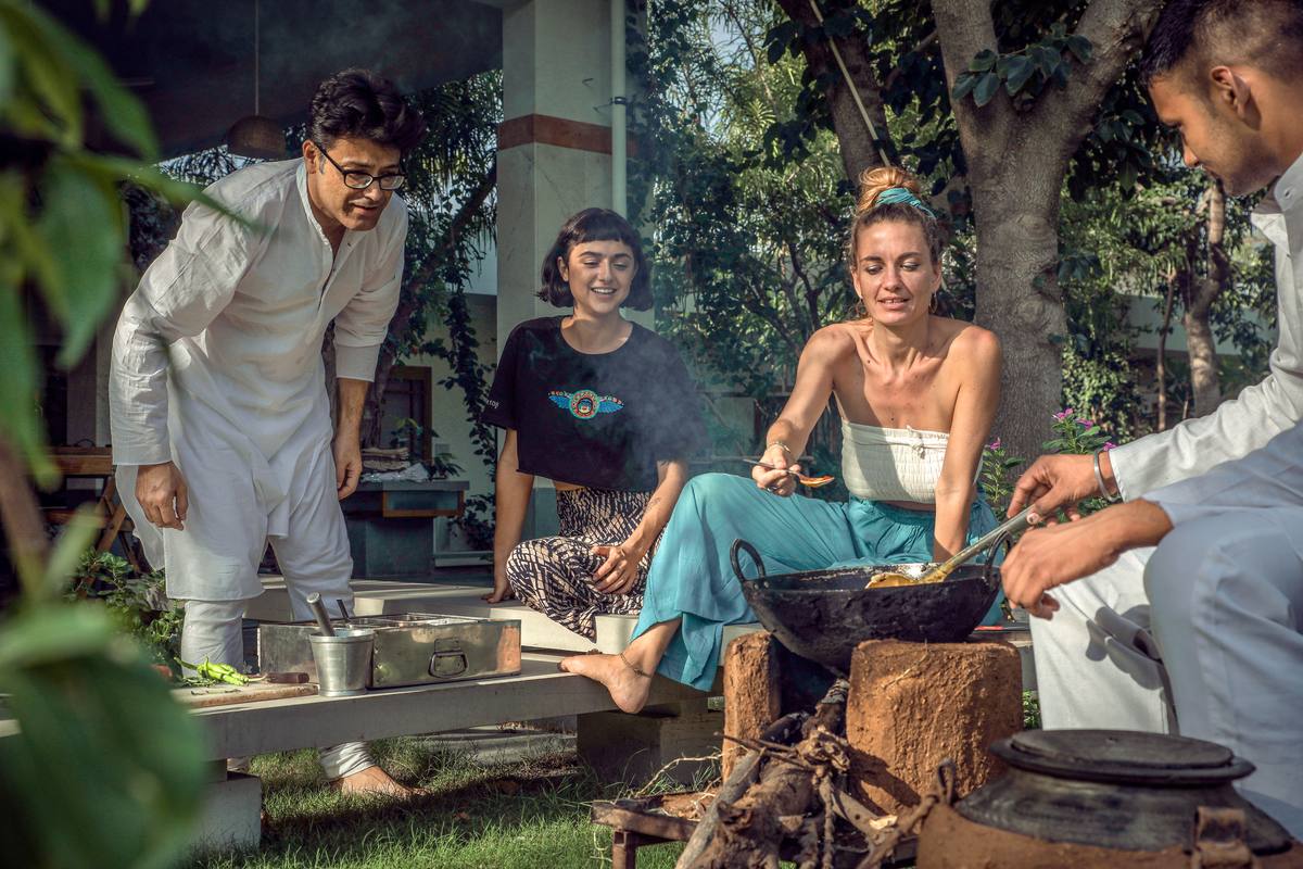 Udai and guests around the outdoor cooking fire