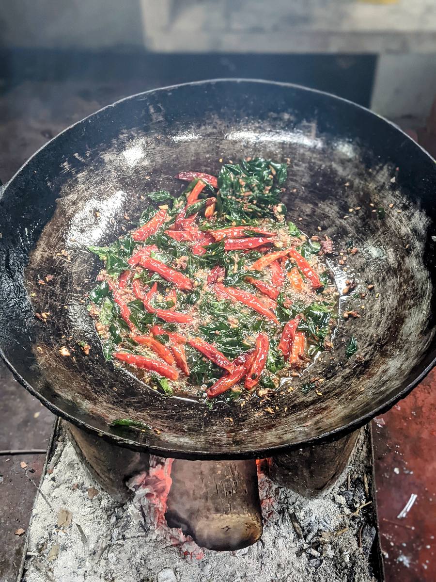 Red chillies frying in the wok