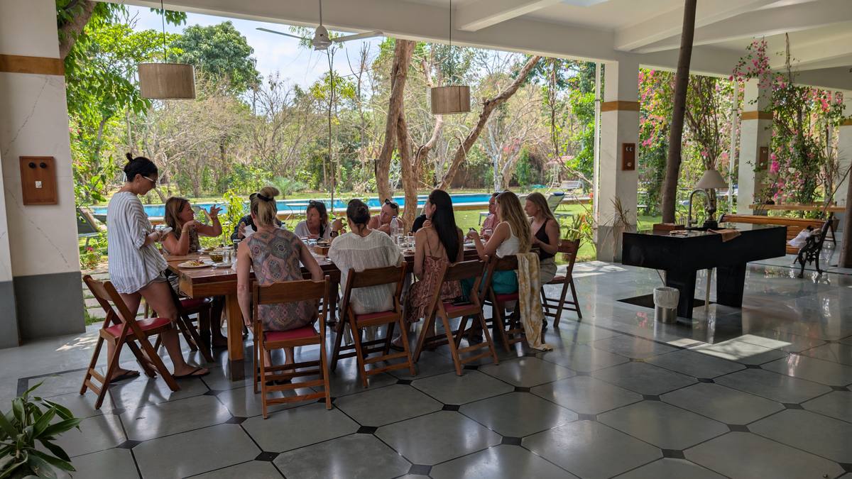 A communal table by the pool set with farm food