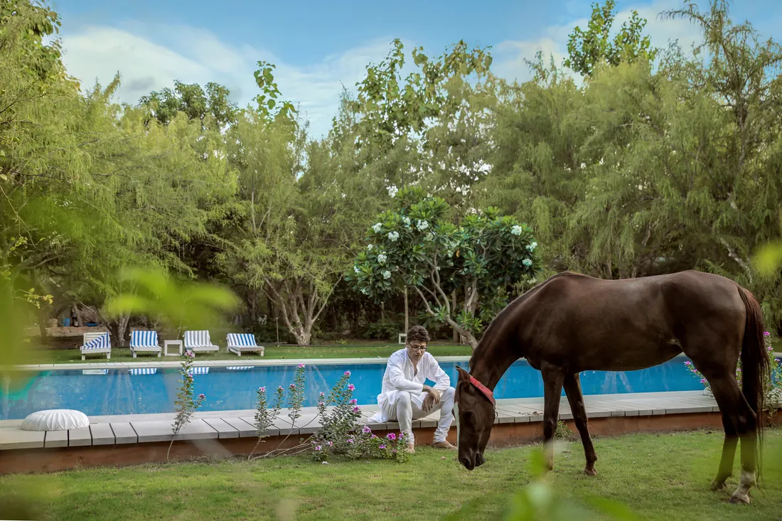 Udai with horse by the pool