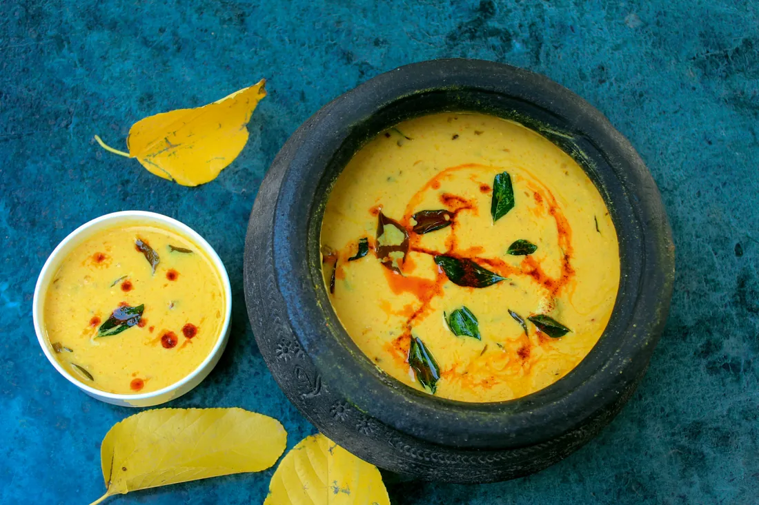 Kadhi in a black clay handi on blue stone