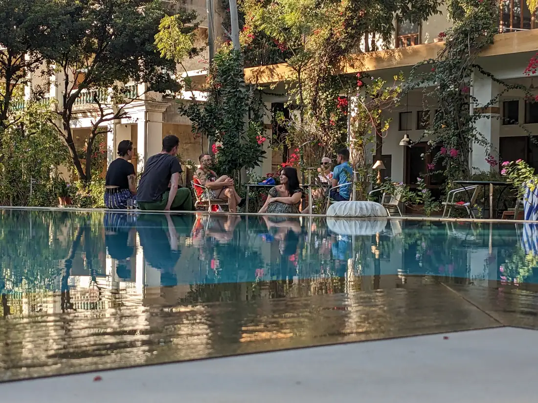 Guests by the pool, reflection — PushkarOrganic