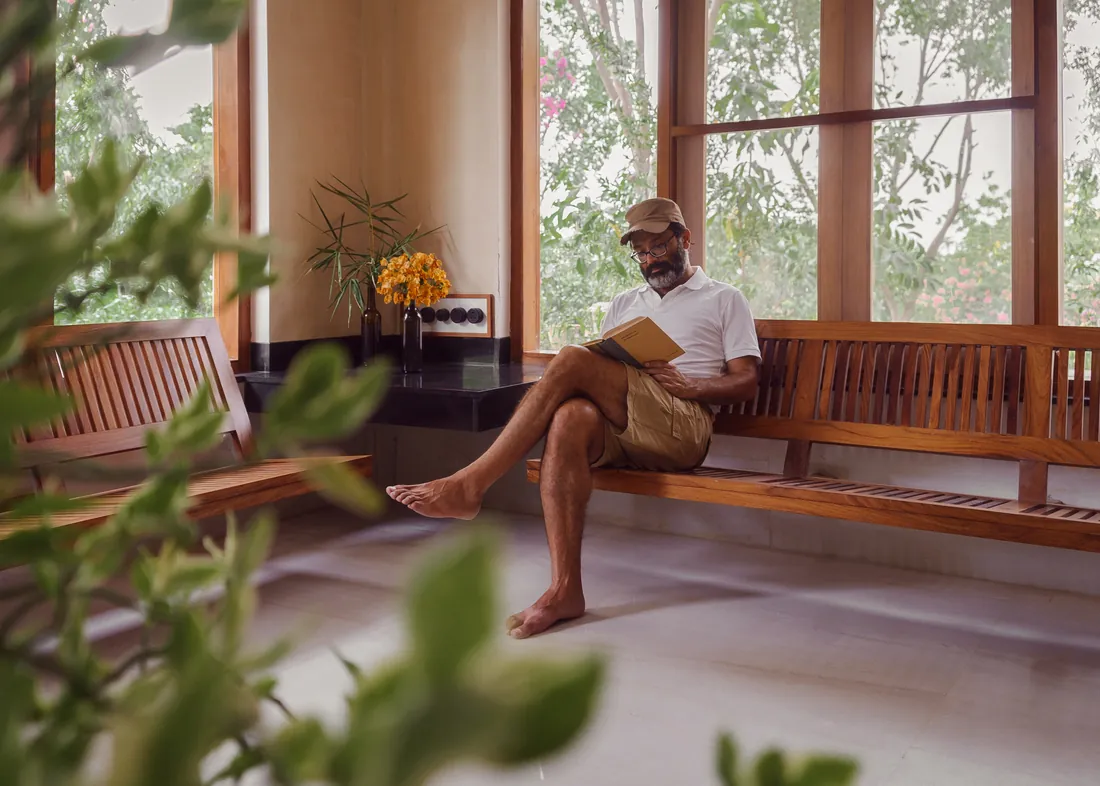 The host, reading, barefoot — PushkarOrganic