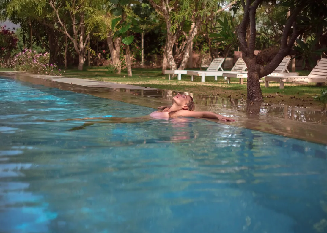 A woman enjoying the pool alone in the quiet garden