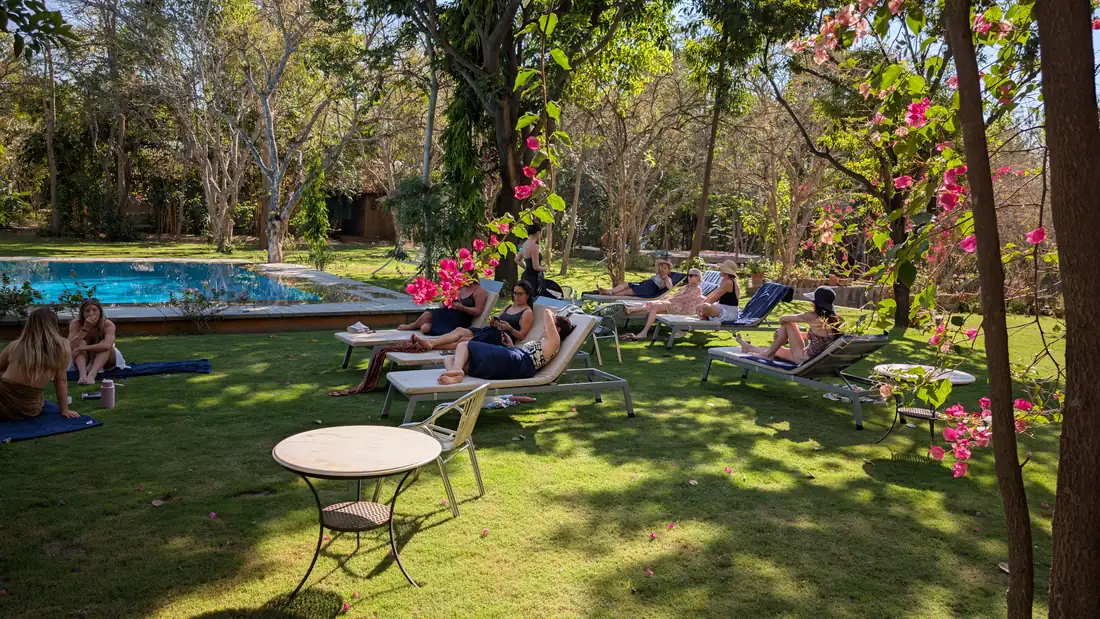 Guests on the lawn beside the pool
