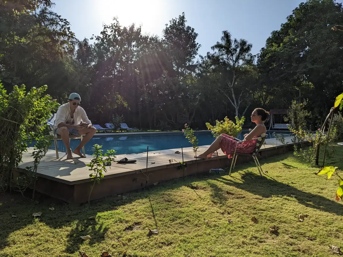 Guests sitting at the edge of the pool