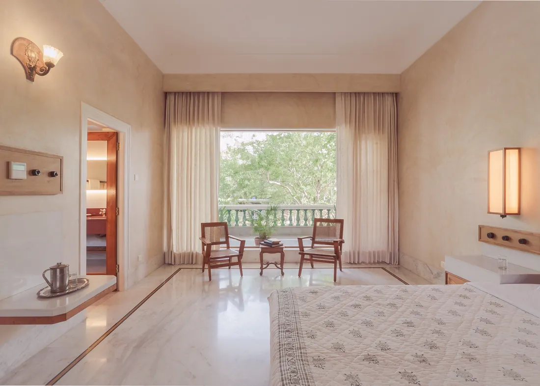 Deluxe room with bed, built-in shelves, wardrobe, and marble floor