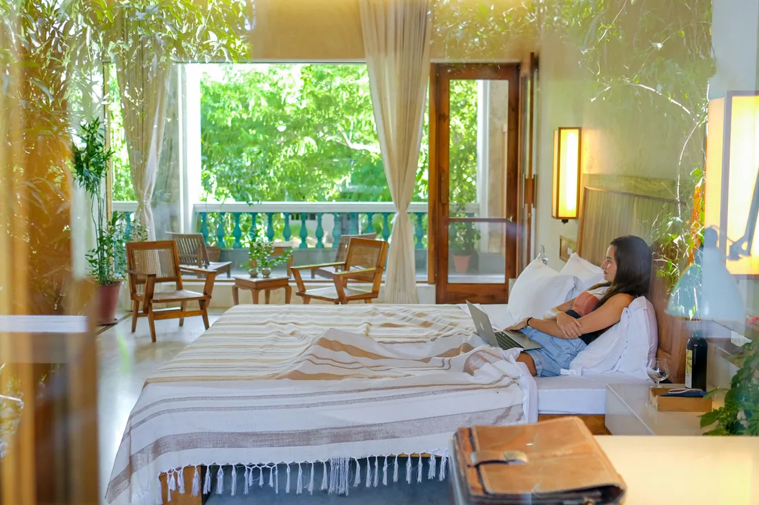 Woman relaxing with a laptop in the Deluxe room