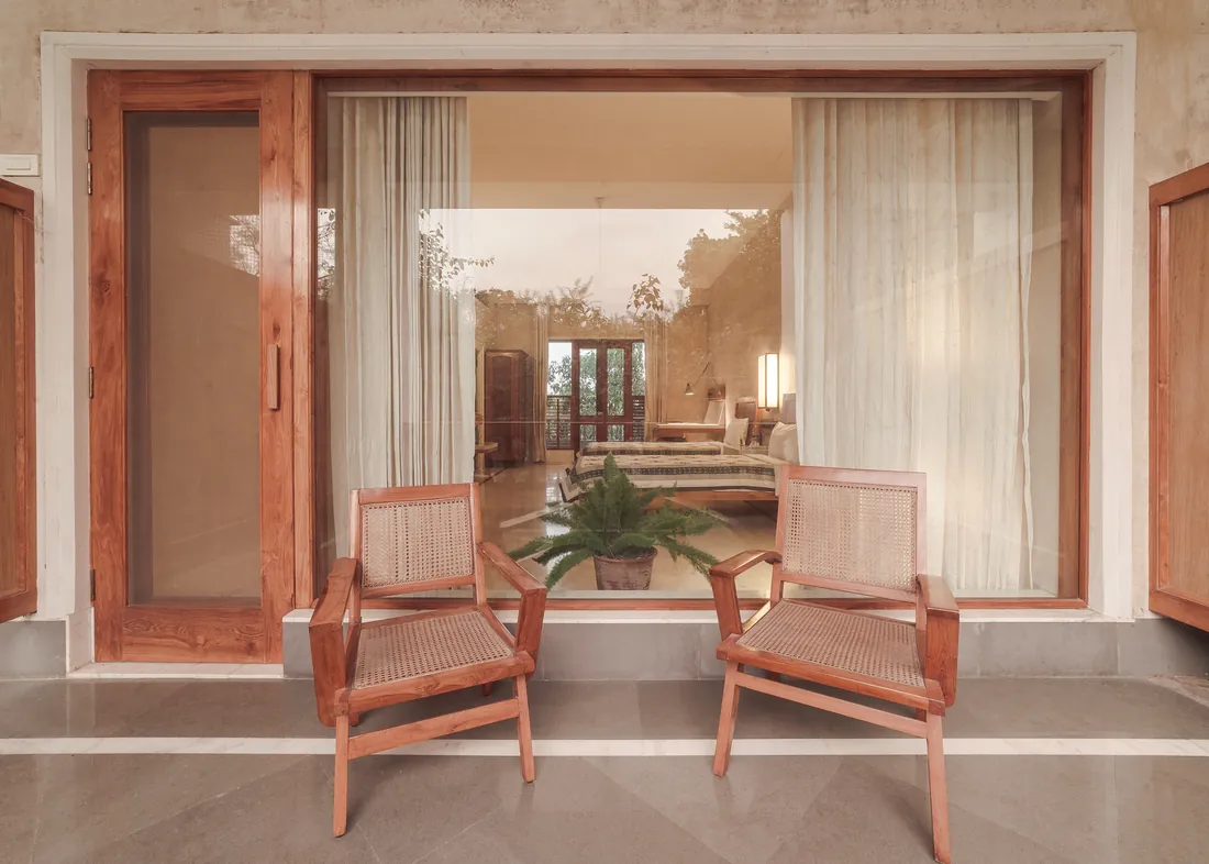 The private balcony — cane chairs looking back into the room