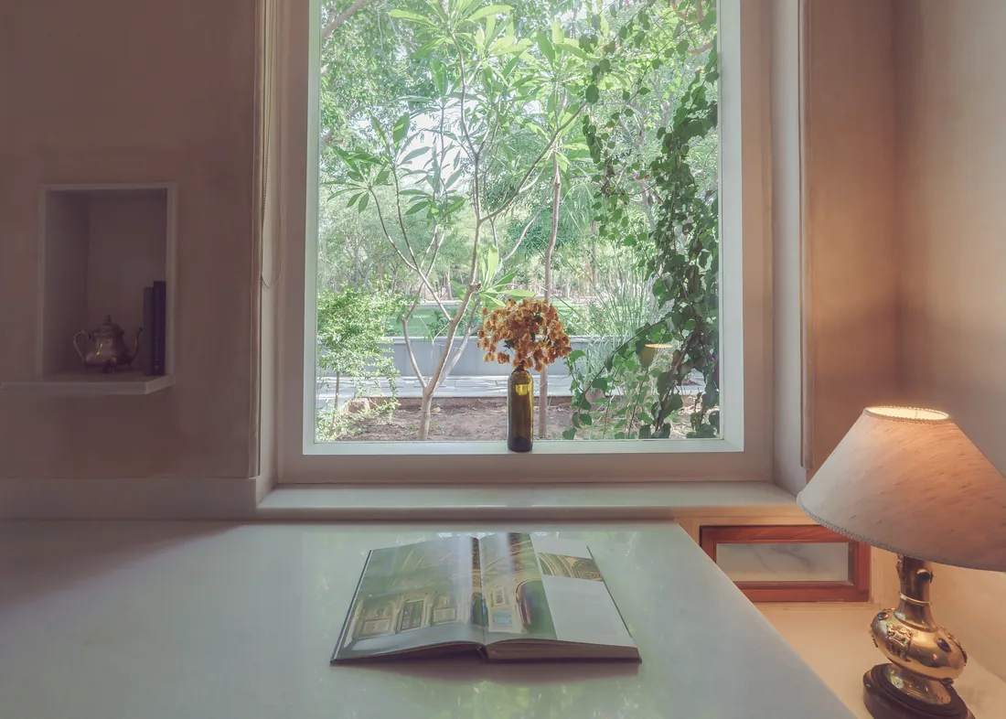 Desk, book, lamp, and window light