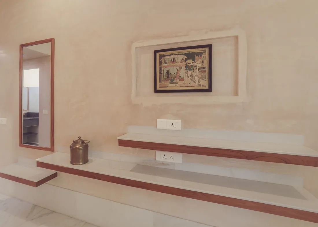 Marble-and-teak shelves, mirror, artwork, and power points