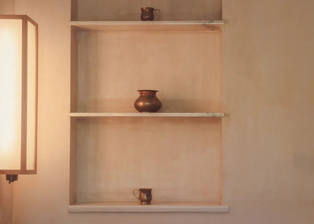 Wall light and recessed marble shelves