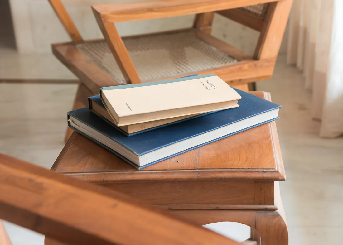 Books beside a cane chair in the Suite work area