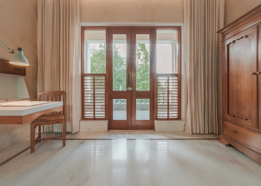 Desk, wardrobe, balcony doors — clean and ordered